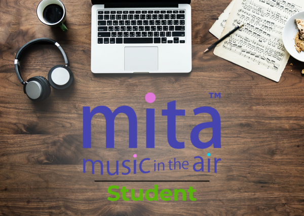 MITA Student logo, with laptop, headphones, score, pen, and coffee mug on desk