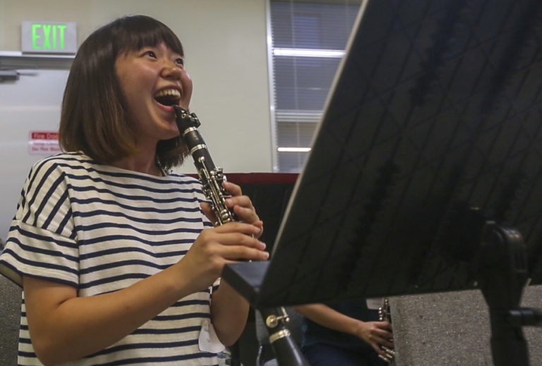 A student laughs during a clarinet lesson. Photo by Daniel Jean-Paul